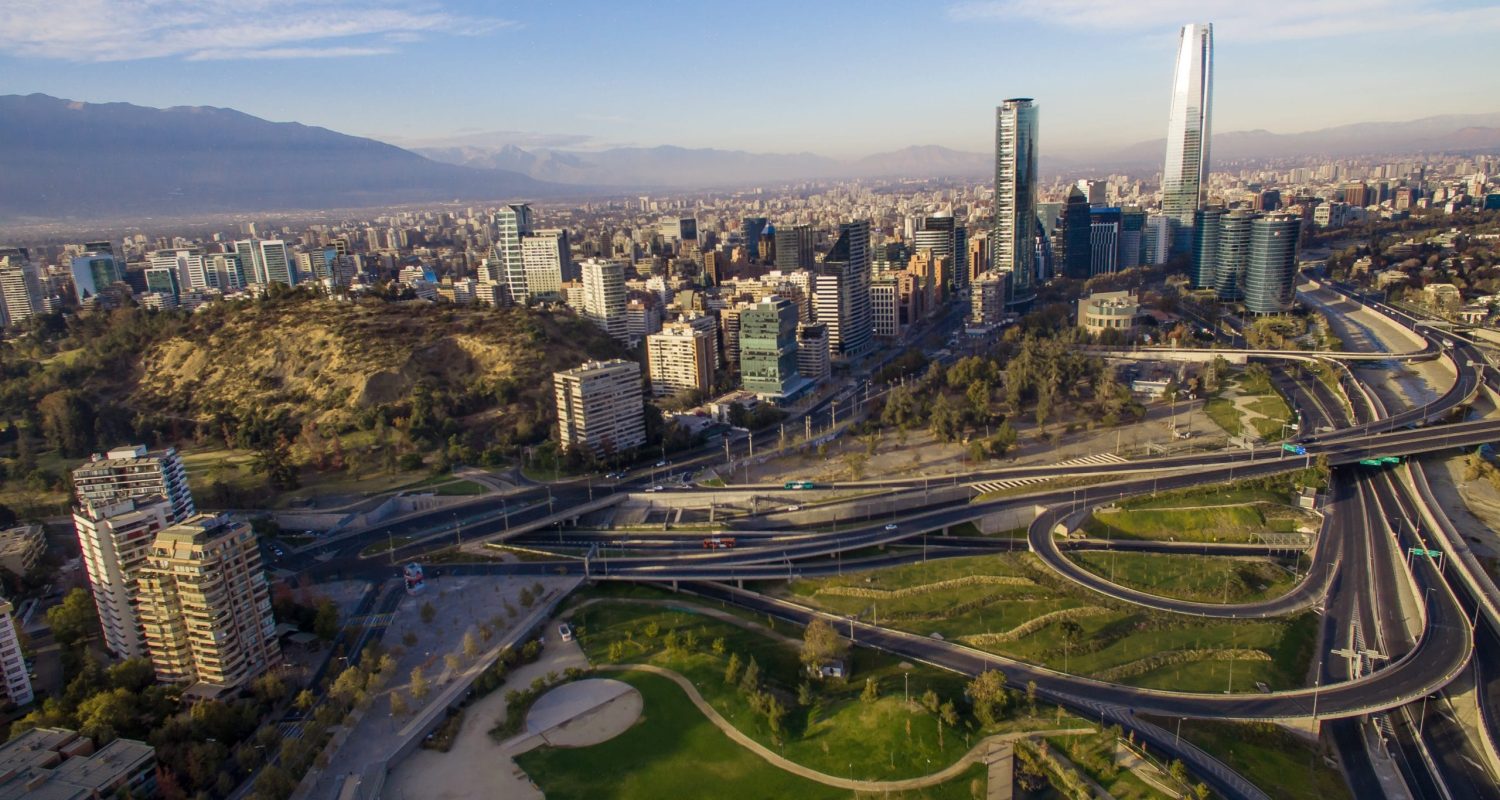 Aerial view of road jungtion and Manquehue hill from Vitacura bicentennial park on a clear day in Chilean capital Santiago.